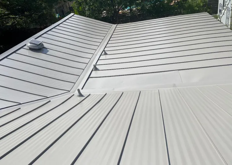 Solar attic fan installed on a metal roof for Roof Ventilation in Moss Point